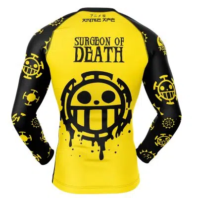 The Trafalgar Law One Piece Long Sleeve Rash Guard Compression Shirt features yellow and black colors, SURGEON OF DEATH, a large smiley logo on the back, and smaller matching logos on the sleeves. Inspired by the anime One Piece.