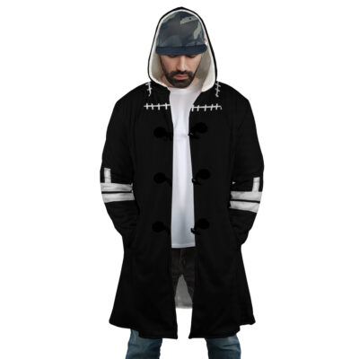 A man wearing the Dabi's Coat My Hero Academia Dream Cloak Coat, featuring black fabric with white stitching and buttons, hands in pockets, a white shirt underneath, and a camouflage cap.
