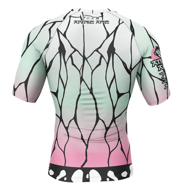 The Shinobu Kocho Demon Slayer Short Sleeve Rash Guard Compression Shirt features a green-to-pink gradient, black web-like lines, white spots near the hem, and stylized text with an eye graphic on the shoulder and upper back.