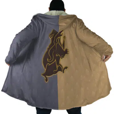 A person wears the Hogwarts Legacy Hufflepuff Harry Potter Dream Cloak Coat, a long hooded coat split purple and tan with a large stylized lion design across the back, spreading it open to show off the design.