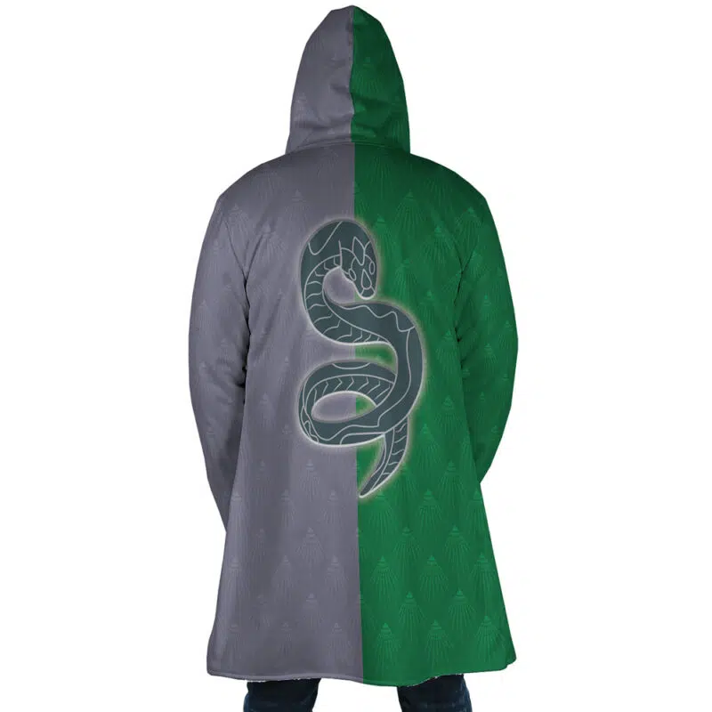 A person wearing the Hogwarts Legacy Slytherin Harry Potter Dream Cloak Coat, featuring gray and green halves with a large snake emblem centered on the back.