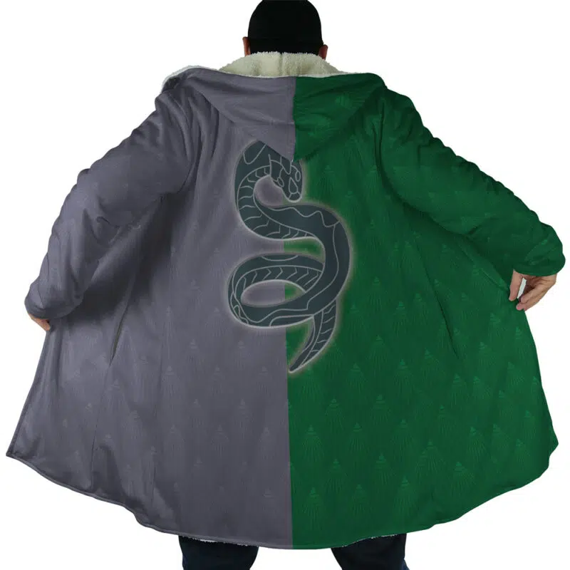 Someone seen from behind wears the Hogwarts Legacy Slytherin Harry Potter Dream Cloak Coat, a long split-color (gray left, green right) design with a large snake emblem on the back and the coat spread open.