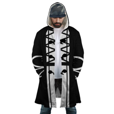 A man wearing the Ichigo Kurosaki Bleach Dream Cloak Coat with bold black and white geometric patterns, over a white shirt and blue jeans, stands with his hands in his coat pockets, looking down.