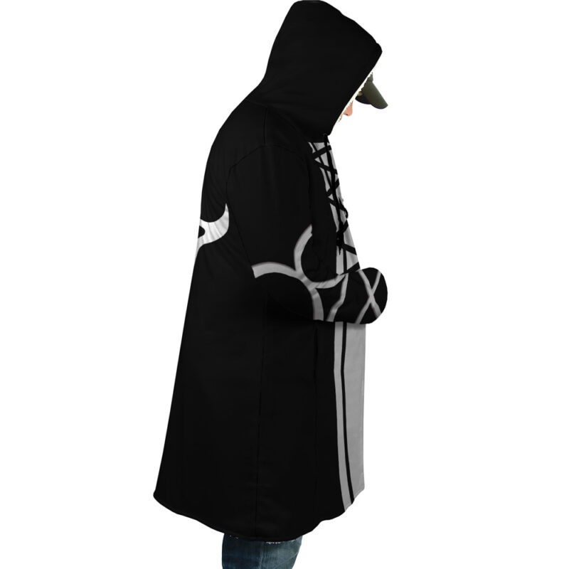 Someone wearing the Ichigo Kurosaki Bleach Dream Cloak Coat—a long black hoodie with white and gray designs, lace-up front details, and hood up—stands in profile against a white background.