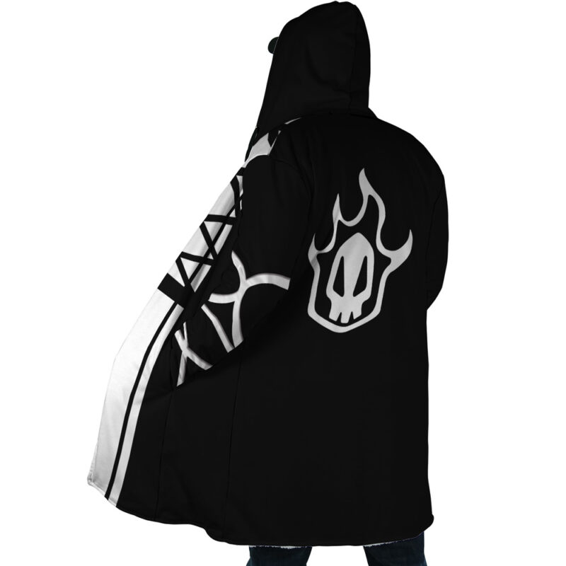 Someone is wearing the Ichigo Kurosaki Bleach Dream Cloak Coat, a black hooded cloak featuring a white flame-skull design on the back and white geometric patterns on one side, shown from behind.