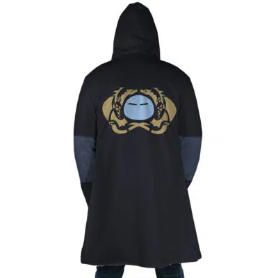 A person seen from the back wears the Rimuru Tempest That Time I Got Reincarnated as a Slime Dream Cloak Coat, a long black hooded coat with a gold and blue emblem of two dragons and a stylized face on the upper back.
