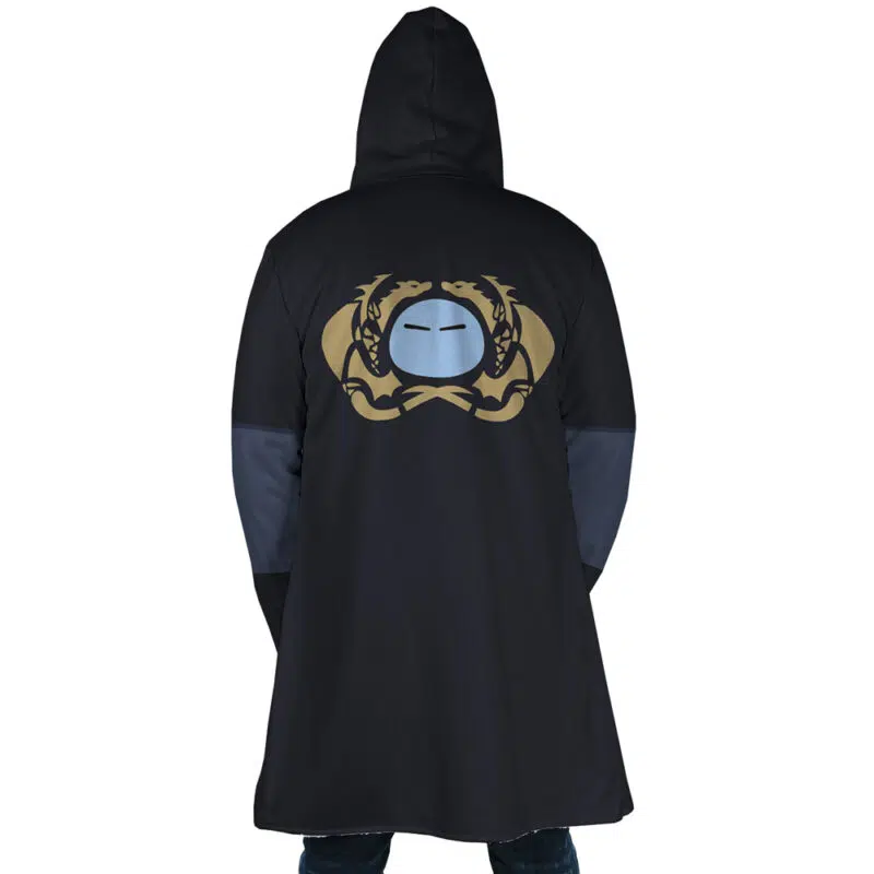 A person seen from the back wears the Rimuru Tempest That Time I Got Reincarnated as a Slime Dream Cloak Coat, a long black hooded coat with a gold and blue emblem of two dragons and a stylized face on the upper back.