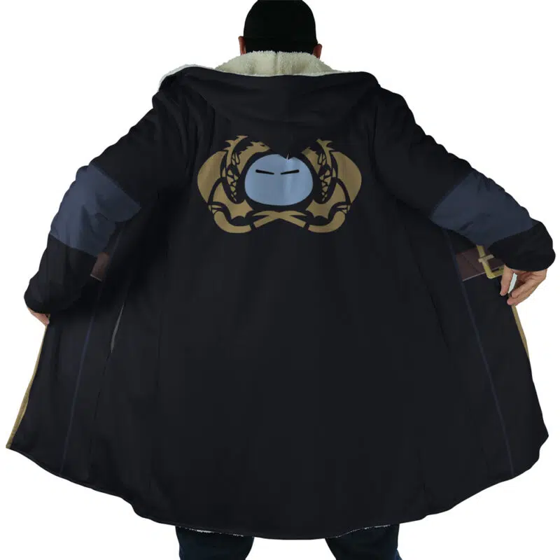 A person is seen from behind wearing the Rimuru Tempest That Time I Got Reincarnated as a Slime Dream Cloak Coat, a long black coat with a large gold and silver emblem of intertwined dragons and a mask on the back. The open coat reveals its wide interior.