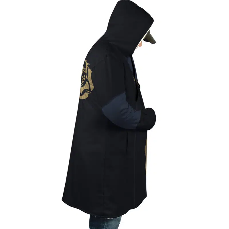 In profile view, a person wears the Rimuru Tempest That Time I Got Reincarnated as a Slime Dream Cloak Coat—long, black with gold accents on sleeve and back—blue sleeves and jeans beneath, cap under hood, and hands in coat pockets.