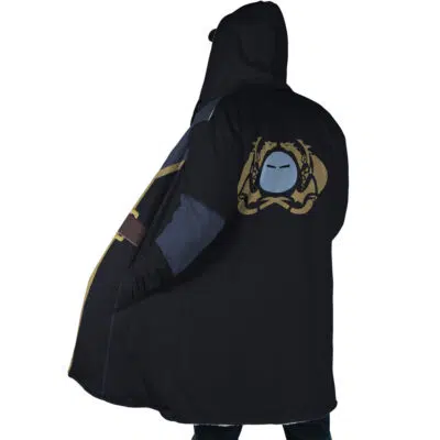 A person stands with their back to the camera, wearing the Rimuru Tempest That Time I Got Reincarnated as a Slime Dream Cloak Coat—black with blue and gold accents, and a large gold and blue masked face emblem on the back.