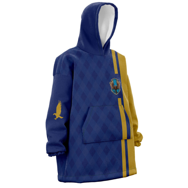 The Ravenclaw Harry Potter Snug Oversized Blanket Hoodie features a blue and gold diamond pattern, large front pocket, yellow side stripes, a raven emblem on the chest, and a gold raven design on the sleeve.