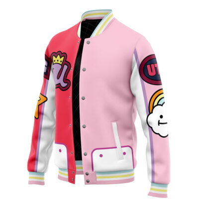 The Uta One Piece Varsity Jacket features pink and red panels, white sleeves, pastel-striped cuffs, and playful cartoon patches—a crown, elephant, star, rainbow, and cloud—for a whimsical look.