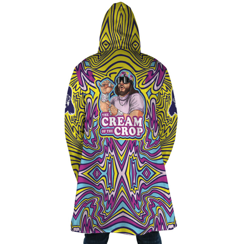 A person wears the Trippy The Cream of the Crop Randy Savage Dream Cloak Coat, a psychedelic hooded robe with an illustrated bearded man in sunglasses holding a creamer and THE CREAM OF THE CROP text on the back.