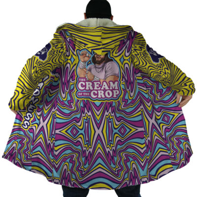 A person wears the Trippy The Cream of the Crop Randy Savage Dream Cloak Coat, featuring bold purple, yellow, and blue psychedelic swirls and a back illustration of a bearded man with a creamer cup and “THE CREAM OF THE CROP” caption.