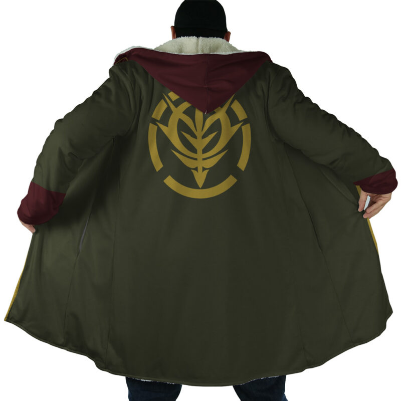 A person wears the Zeon Uniform Gundam Dream Cloak Coat, a long dark green coat with maroon hood and cuffs, holding it open to reveal a large gold leaf-like emblem on the back.