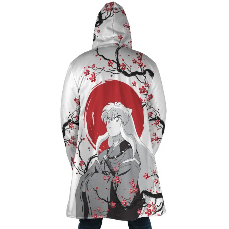 Someone wears the Inuyasha Cherry Blossom Dream Cloak Coat, which features an anime character with long white hair in front of a red sun, surrounded by black branches and red cherry blossoms across the entire back.