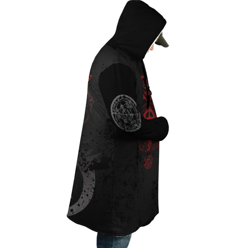 Wearing the Transmutation Circle Fullmetal Alchemist Dream Cloak Coat, a person in jeans and a cap stands in profile against a white background, hands in pockets and head slightly bowed under the hood.