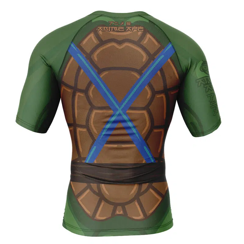The Leonardo Teenage Mutant Ninja Turtles Short Sleeve Rash Guard Compression Shirt features a green base, turtle shell design on the back, and two blue sword straps in a comic style.