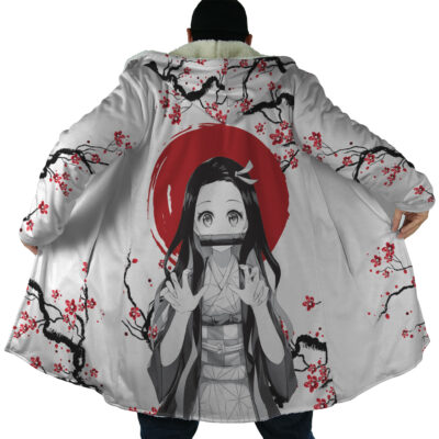 A person displays the Nezuko Kamado Cherry Blossom Demon Slayer Dream Cloak Coat, featuring cherry blossom branches and Nezuko with long hair and a bamboo gag, set against a red circle on the back.