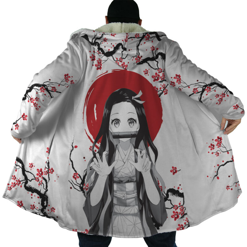 A person displays the Nezuko Kamado Cherry Blossom Demon Slayer Dream Cloak Coat, featuring cherry blossom branches and Nezuko with long hair and a bamboo gag, set against a red circle on the back.