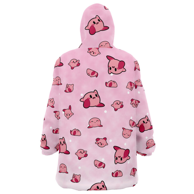 The Kirby Pattern Nintendo Snug Oversized Blanket Hoodie features a pink design with cute cartoon Kirbys in different poses and expressions scattered across the fabric, plus more Kirby faces on the hood.