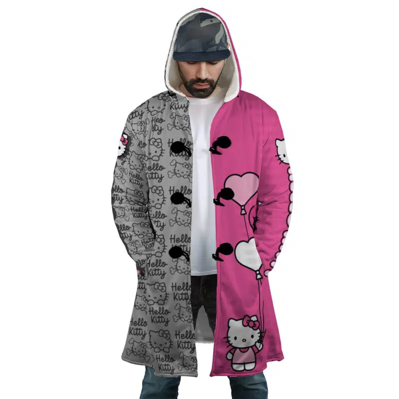 A man wears the Hello Kitty Sanrio Dream Cloak Coat: its split design features a gray side with Hello Kitty text/faces and a pink side with Hello Kitty holding heart-shaped balloons.