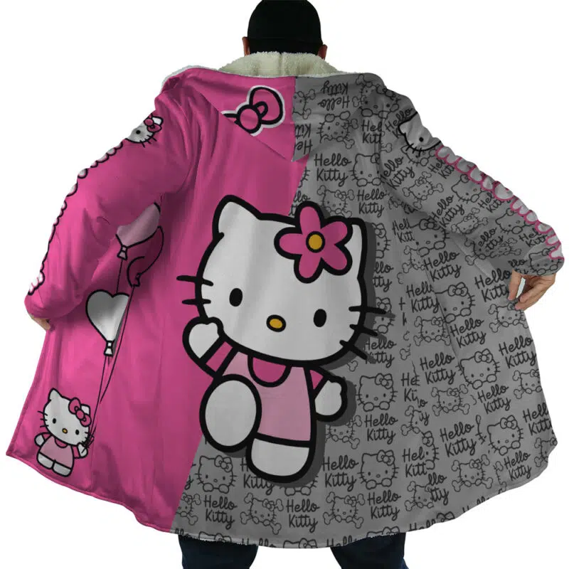 A person faces away from the camera wearing the Hello Kitty Sanrio Dream Cloak Coat, a long, colorful coat with large Hello Kitty graphics and pink, gray, and white patterns, showing the character holding balloons and waving.