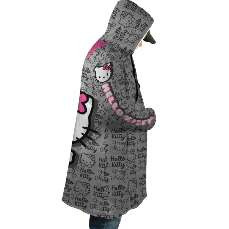 Someone wears the Hello Kitty Sanrio Dream Cloak Coat, a black and white hooded coat with pink accents. It features repeated Hello Kitty faces, the logo, and large Hello Kitty text throughout the fabric.