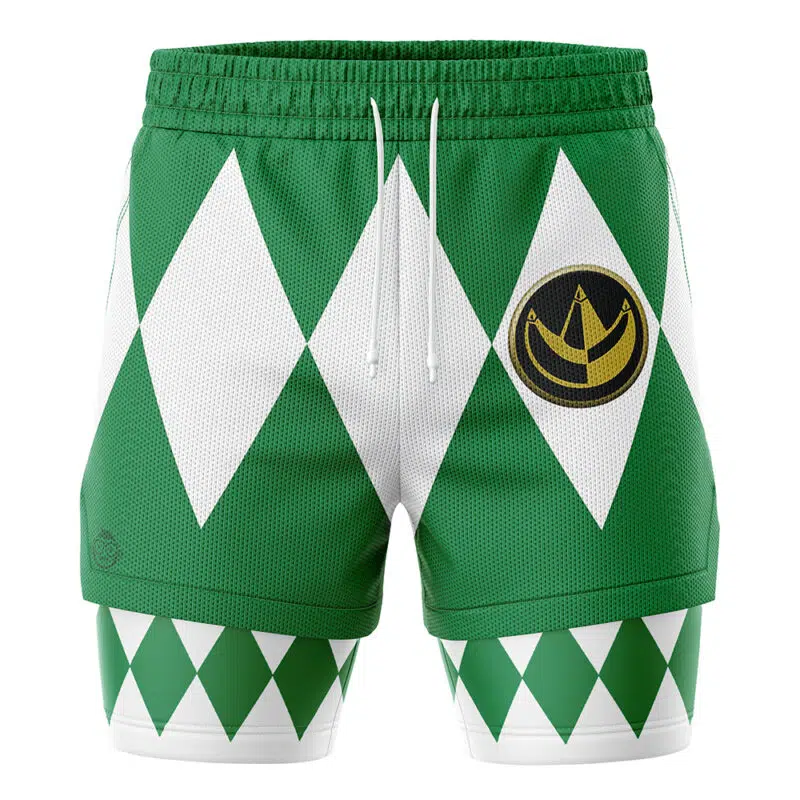The Green Ranger V1 Mighty Morphin Power Rangers 2-in-1 Performance Shorts feature a white diamond pattern, drawstring waistband, and gold circular emblem on the left thigh, with additional green and white diamonds on the lower legs.