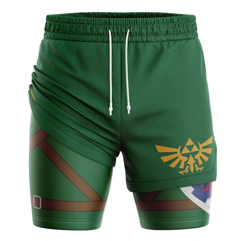 The Link Legend of Zelda 2-in-1 Performance Shorts are green athletic shorts with a drawstring, yellow Hylian crest, brown belt details, and a partial shield graphic on the left leg—perfect for Zelda fans.