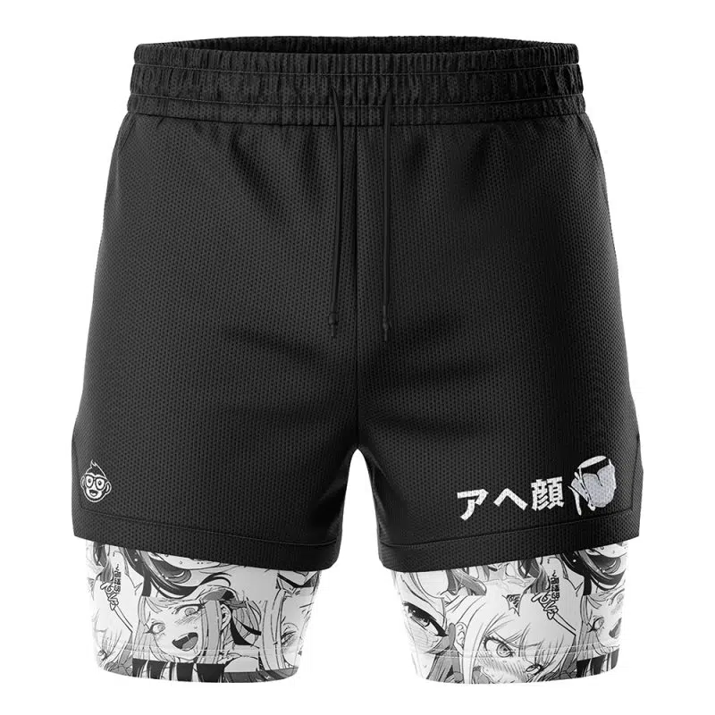 The Ahegao Manga 2-in-1 Performance Shorts are black athletic shorts with a drawstring waist, featuring manga-style expressive faces on the inner lining and Japanese text with a small character graphic on one leg.