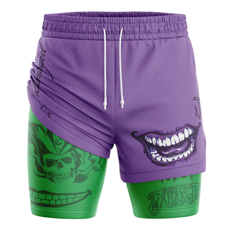 The Joker DC Comics 2-in-1 Performance Shorts feature purple fabric with a drawstring, a bold comic-style grinning mouth on the right, and green sections with skull and Joker-themed graphics on the left leg.