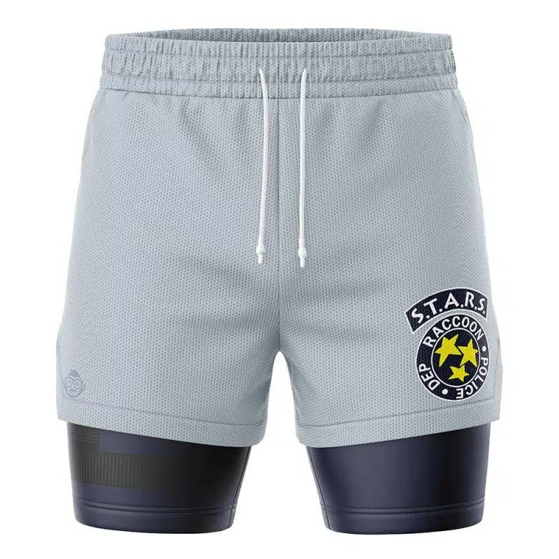 The STARS Resident Evil 2-in-1 Performance Shorts are light gray athletic shorts with a white drawstring and a S.T.A.R.S. Raccoon Police Department patch on the right leg, worn over dark compression shorts.