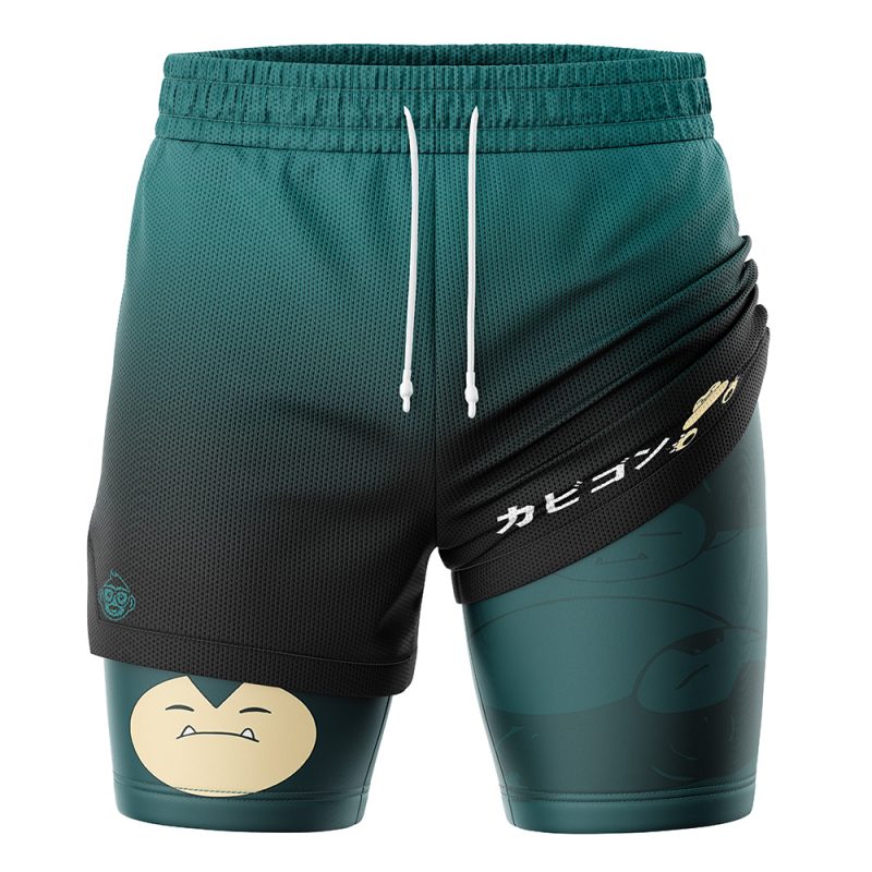 The Snorlax Pokemon 2-in-1 Performance Shorts are dark green with a layered design, featuring a cartoon Snorlax face on one leg and Japanese text with a small Snorlax graphic on the other, plus white drawstrings at the waistband.