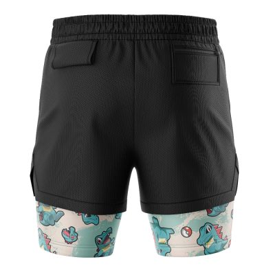 Totodile Pattern Pokemon 2-in-1 Performance Shorts feature black mesh outer layer, a blue inner layer with Totodile, Poké Balls, and fun expressions. These shorts include pockets and a comfy elastic waistband.