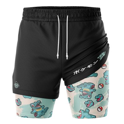 The Totodile Pattern Pokemon 2-in-1 Performance Shorts feature a black layered design with a Totodile and Poké Ball print inner layer, plus white Japanese text and a Totodile graphic on the right side.