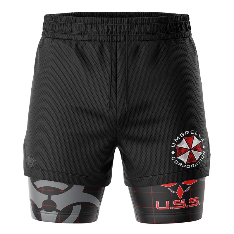 The Umbrella Corp Resident Evil 2-in-1 Performance Shorts feature black athletic fabric, an elastic waistband, the Umbrella Corporation logo, U.S.S. in red on a grid pattern, and gray biohazard symbols on the compression layer.
