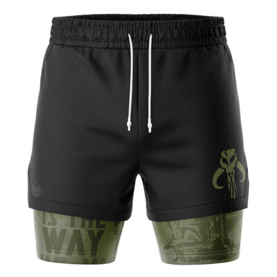 The Mandalorian Star Wars 2-in-1 Performance Shorts feature black athletic shorts with white drawstrings, a green Mandalorian symbol on the right thigh, and an olive green compression layer beneath with faint patterns and THIS IS THE WAY text.