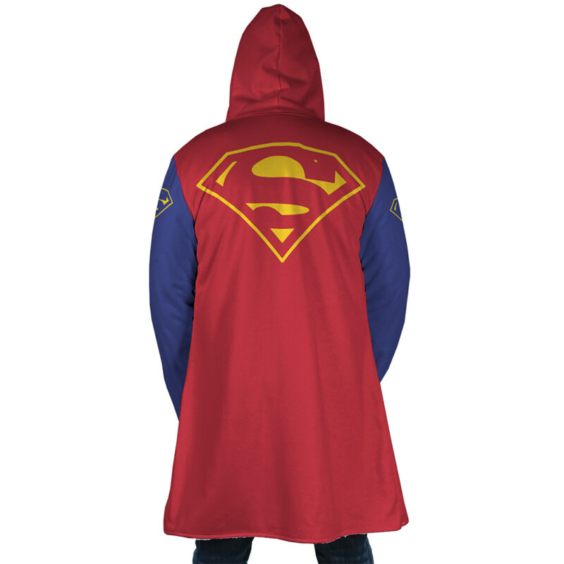 A person is seen from behind wearing the Superman DC Comics Dream Cloak Coat, featuring a red and blue design with the yellow Superman logo on the back and sleeves.