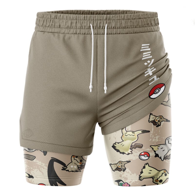 The Umbreon Trippy Pokemon 2-in-1 Performance Shorts feature tan fabric with white drawstrings, Japanese text, and a Pokéball on the side. The inner layer displays multiple Pokémon and Pokéballs on a beige background.