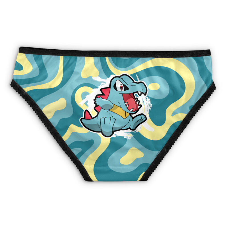 Children’s underwear featuring Psyduck’s face from Pokémon on the front, set against a wavy yellow and turquoise abstract background with black trim.