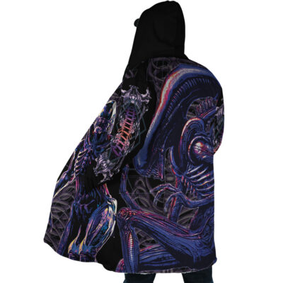 Someone wears the Yautja Predator Dream Cloak Coat, featuring dark biomechanical, alien-like designs in vivid purple, blue, and pink hues, standing against a white background.