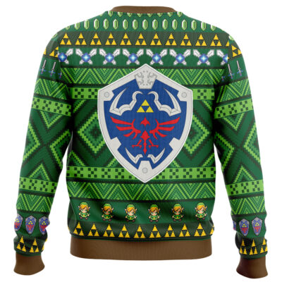 The Majora's Mask The Legend of Zelda Ugly Christmas Sweater features green fabric with geometric patterns, a bold blue and silver shield with a red bird on the back, yellow triangles, sword icons, and rows of green-outfitted characters along the hem.