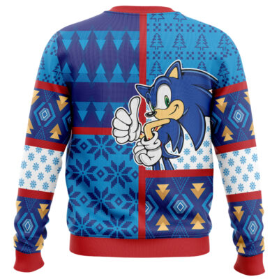 The Super Mario Gaming Ugly Christmas Sweater features Mario giving a thumbs up, surrounded by blue, red, and white geometric and snowflake patterns, yellow trees, and finished with a red ribbed collar, cuffs, and hem.
