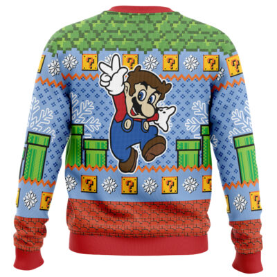 The Super Mario Kart Gaming Ugly Christmas Sweater features a pixelated Mario jumping, green pipes, question mark blocks, snowflakes, and a red-and-blue color scheme inspired by classic video game graphics.