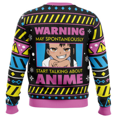 A colorful "I Paused My Anime To Be Here Ugly Christmas Sweater" with warning signs, geometric patterns, and an anime character with mischievous eyes. Text reads: WARNING May Spontaneously Start Talking About Anime.