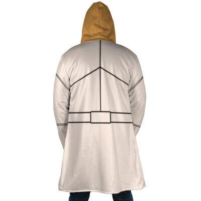 A person is seen from the back wearing the Mikey Sano Manjiro Flannel Tokyo Revengers Dream Cloak Coat, a long beige hooded coat with a brown hood and black geometric line designs reminiscent of stylized armor.