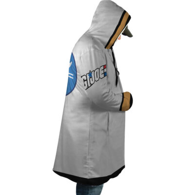 A person wears the Tanya von Degurechaff The Saga of Tanya the Evil Dream Cloak Coat (Copy), a long gray hooded coat with tan accents, featuring an emblem on the back and patch on the side, facing right with hands in pockets and a cap under the hood.