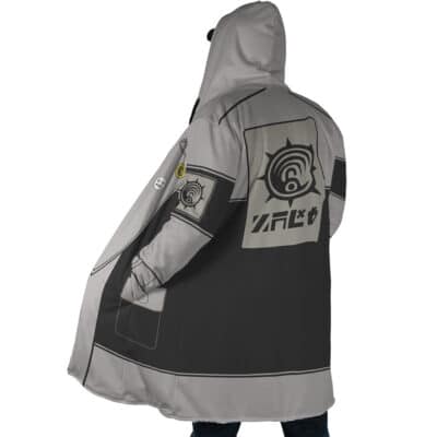A person wearing the Sidon The Legend of Zelda Dream Cloak Coat, a loose gray and black hooded coat featuring large printed designs and symbols on the back and sleeve, stands with their back to the camera.