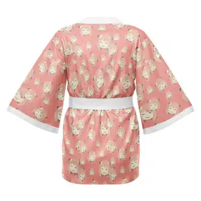 The Death the Kid Soul Eater Happi Coat Haori Kimono features a pink design with wide sleeves, a white belt, and a repeating cartoon face pattern with blonde hair and cheerful expressions. Shown from the back.
